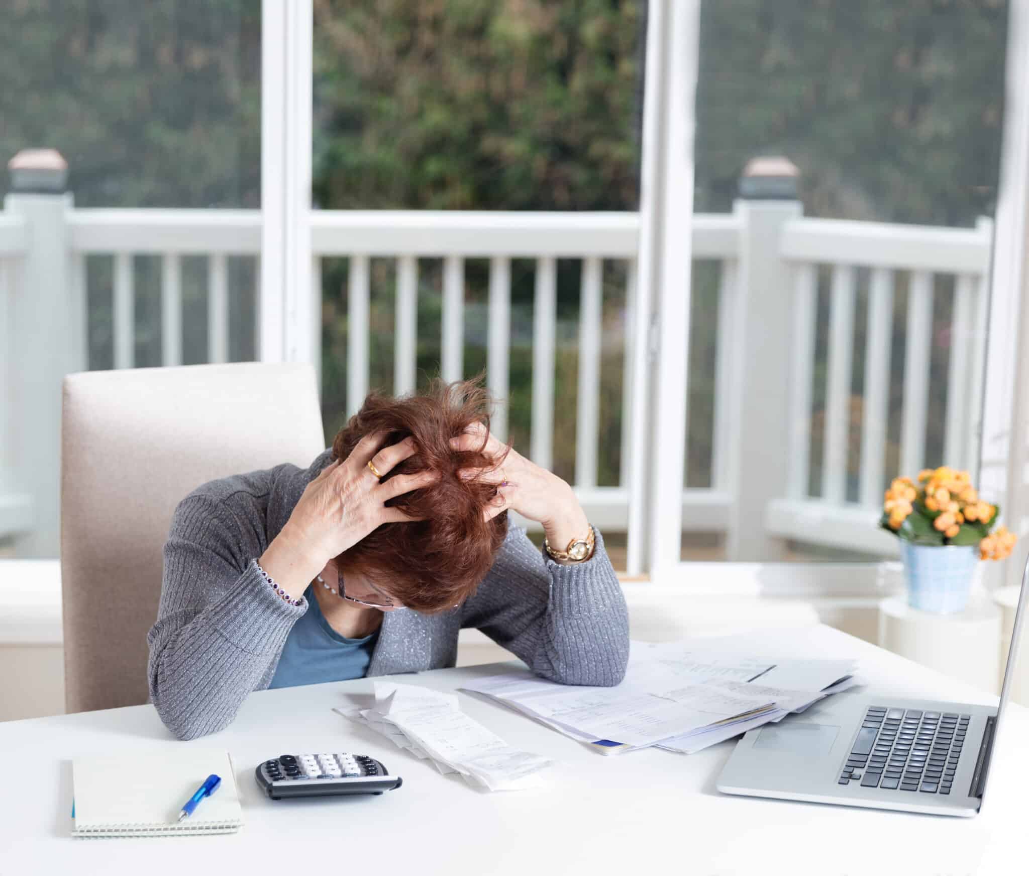 Woman depressed doing her financial bills, Working capital solutions.